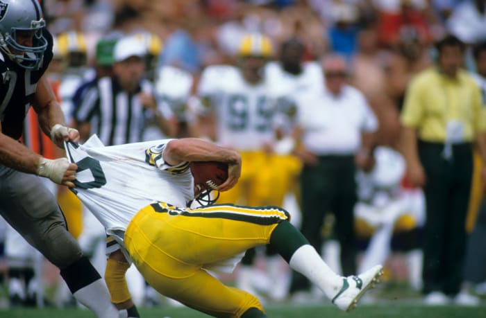 Howie Long gets shirty with Packers quarterback Randy Wright during the 1984 season.